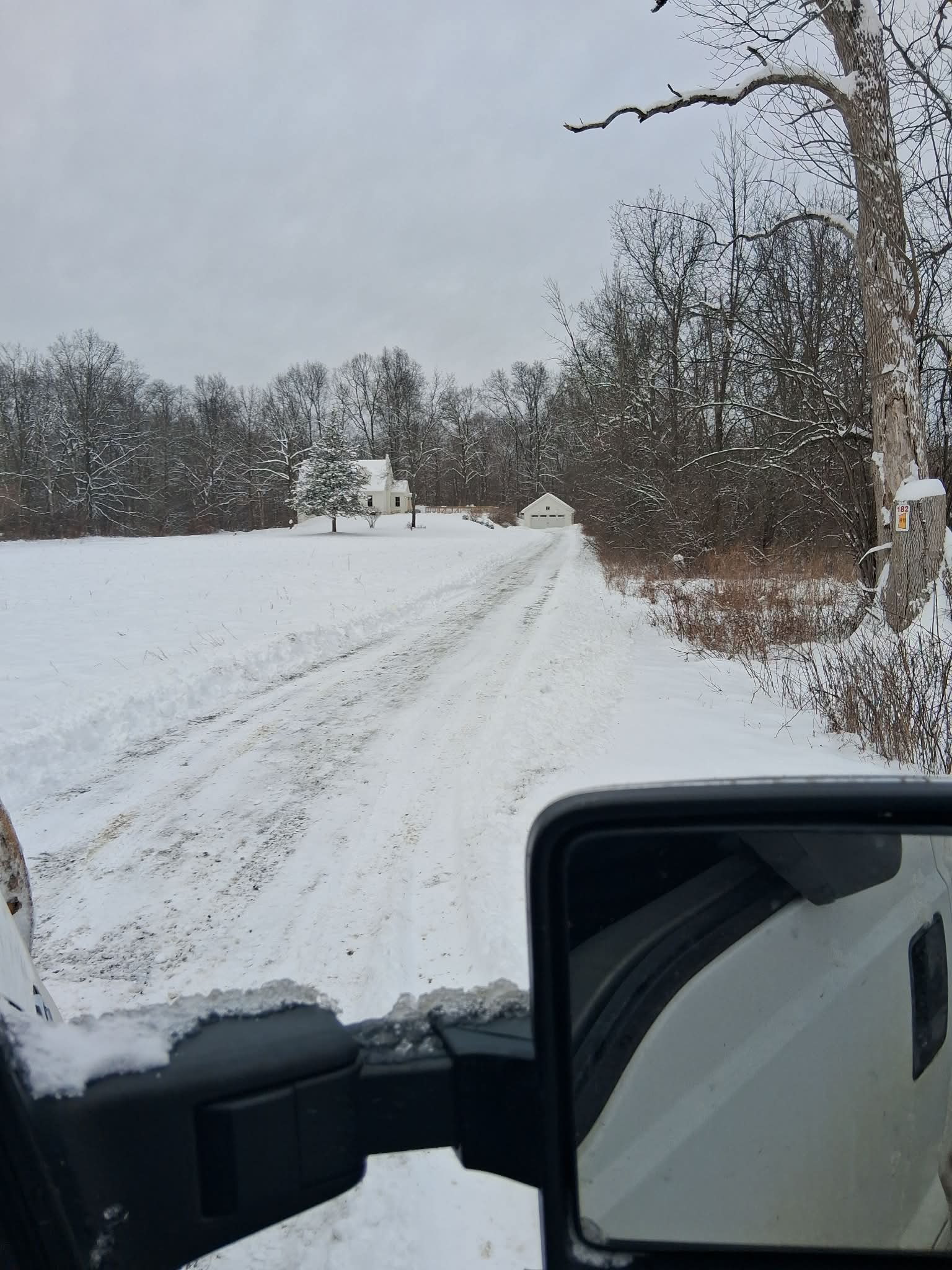 Winter property maintenance - snow plow truck at residential property